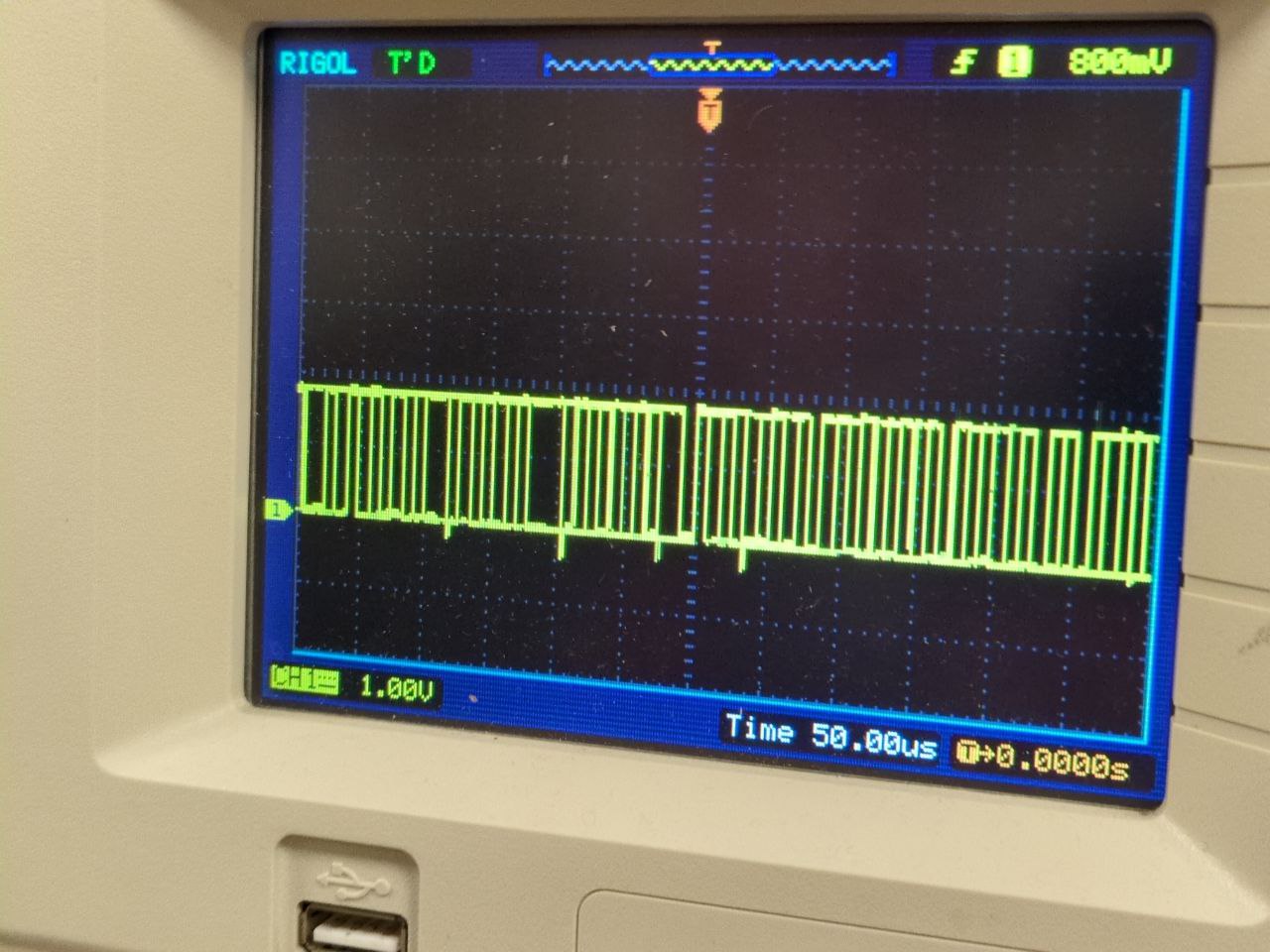 photo of digital oscilloscope with blocky waveform